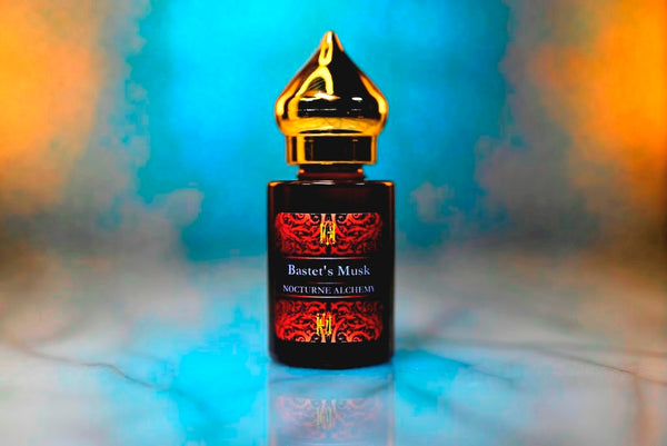 6ml amber cylindrical bottle with gold-toned domed lid and insert. Bastet's Musk.