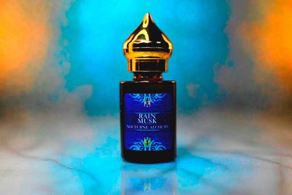 6ml amber cylindrical bottle with gold-toned domed lid and insert.  Rain Musk