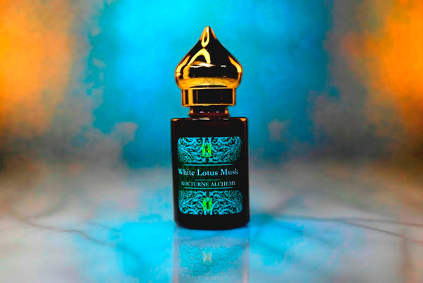 6ml amber cylindrical bottle with gold-toned domed lid and insert.  White Lotus Musk