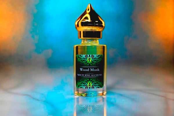 6ml clear cylindrical bottle with gold-toned domed lid and insert.  Wood Musk