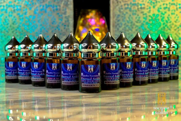 full set of all twelve Bastet's Eternal Ankh Jardin Nocturne perfumes each in 6ml amber cylindrical bottle with flat insert dropper and silver-toned twist domed lid