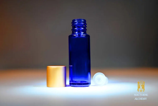 Empty Slender Blue Bottle with matte gold lid and plastic insert dropper