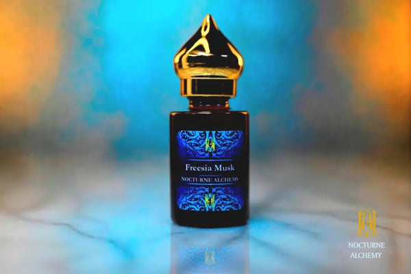 6ml amber cylindrical bottle with gold-toned domed lid and insert.  Freesia Musk